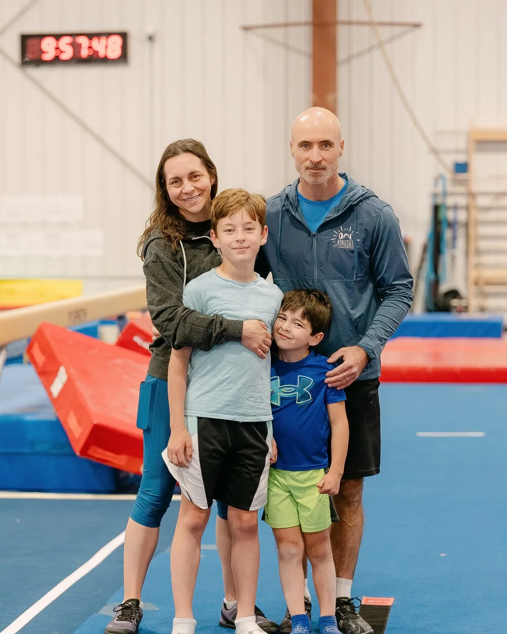 Owner and head coach Valentin Frunzac with his family on the ONE Athletics gym floor